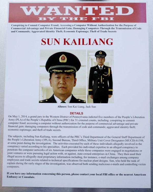 This wanted poster is displayed at the U.S. Justice Department in Washington on May 19, 2014. A U.S. grand jury has charged five Chinese hackers with economic espionage and trade secret theft, the first-of-its-kind criminal charges against Chinese military officials in an international cyber espionage case. (AP Photo)