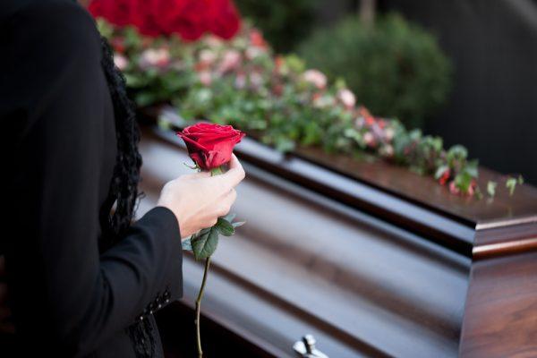 A stock photo shows a mourner at a funeral (Shutterstock*)