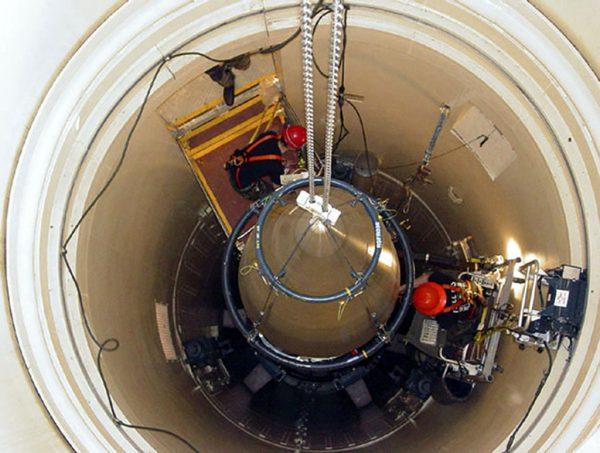 A maintenance team removes the upper section of an ICBM at a silo near Malmstrom Air Force Base in Montana. (AP Photo/U.S. Air Force, John Parie)