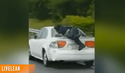 Man Rides on Trunk of Car in the Middle of the Highway (Video)