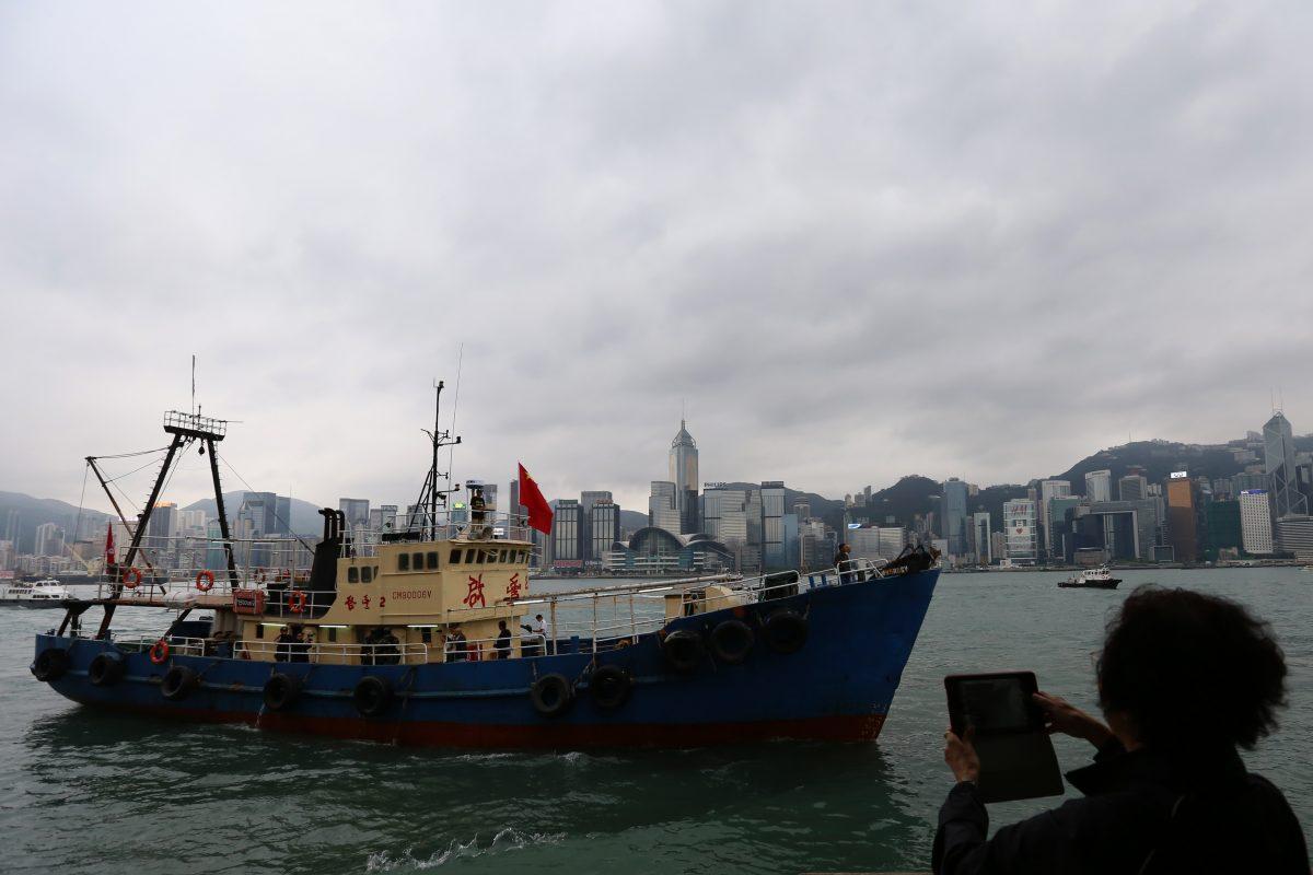 A Chinese fishing boat, which landed on one of Japan's Senkaku islands, sails into Victoria Harbor in Hong Kong on Nov. 13, 2013. Through a new system, China is militarizing its fishing ships. (Aaron Tam/AFP/Getty Images)