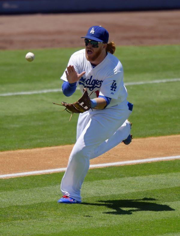 Los Angeles Dodgers third baseman Justin Turner makes a catch on a ball hit by Milwaukee Brewers' Wily Peralta during the second inning of a baseball game, Sunday, Aug. 17, 2014, in Los Angeles. (Mark J. Terrill/AP Photo)