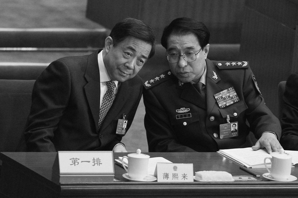 General Xu Caihou (right), then-Vice Chairman of the Communist Party of China's Central Military Commission, talks with China's Chongqing Municipality Communist Party Secretary Bo Xilai during the opening ceremony of the National People's Congress at the Great Hall of the People on March 5, 2012, in Beijing, China. (Feng Li/Getty Images)