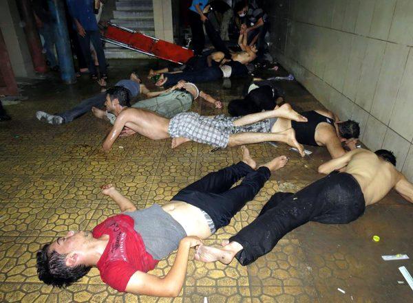 This Wednesday, Aug. 21, 2013 file photo made by a citizen journalist provided by the Media Office Of Douma City which has been authenticated based on its contents and other AP reporting, shows Syrian men lying on the ground as they wait for treatment after an alleged poisonous gas attack fired by regime forces, according to activists in Douma town, Damascus, Syria. An international human rights group says on the anniversary of the deadly chemical attack outside Damascus that “justice remains elusive” for the victims and their families. (AP Photo/Media Office Of Douma City, File)