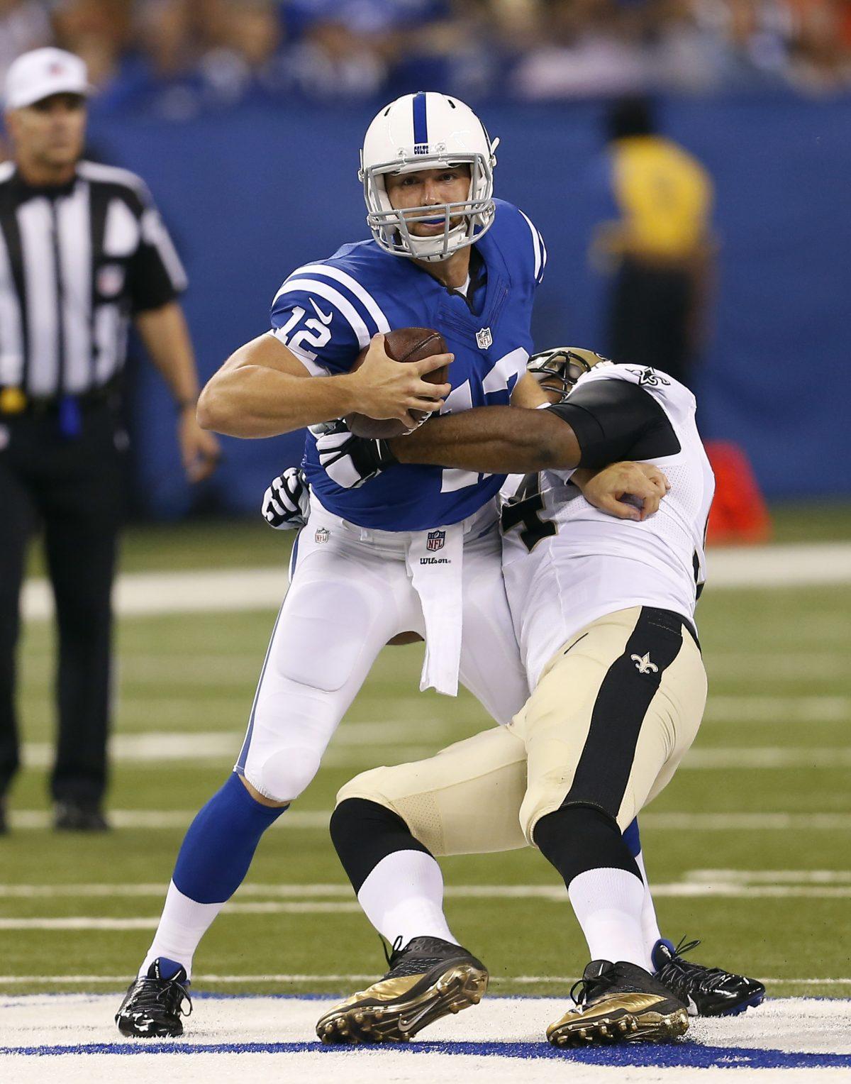 Indianapolis Colts quarterback Andrew Luck (L) is hit by New Orleans Saints defensive end Cameron Jordan during the first half of an NFL preseason football game in Indianapolis, on Aug. 23, 2014. (Sam Riche/AP Photo)