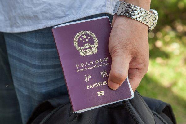 A Chinese national holds a Chinese Passport. (Omar Havana/Getty Images)