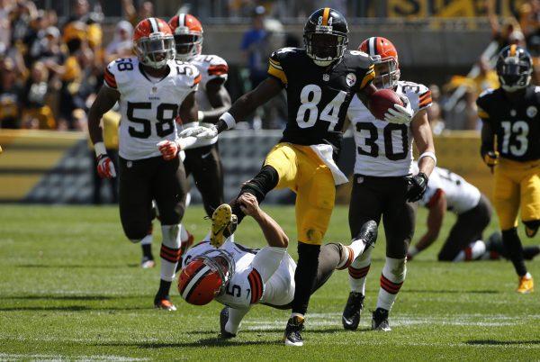 Pittsburgh Steelers Antonio Brown (84) kicks Cleveland Browns punter Spencer Lanning (5) as he jumps while returning a punt in the second quarter of the NFL football game on Sunday, Sept. 7, 2014 in Pittsburgh. Brown was penalized for unnecessary roughness on the play. (AP Photo/Gene J. Puskar)