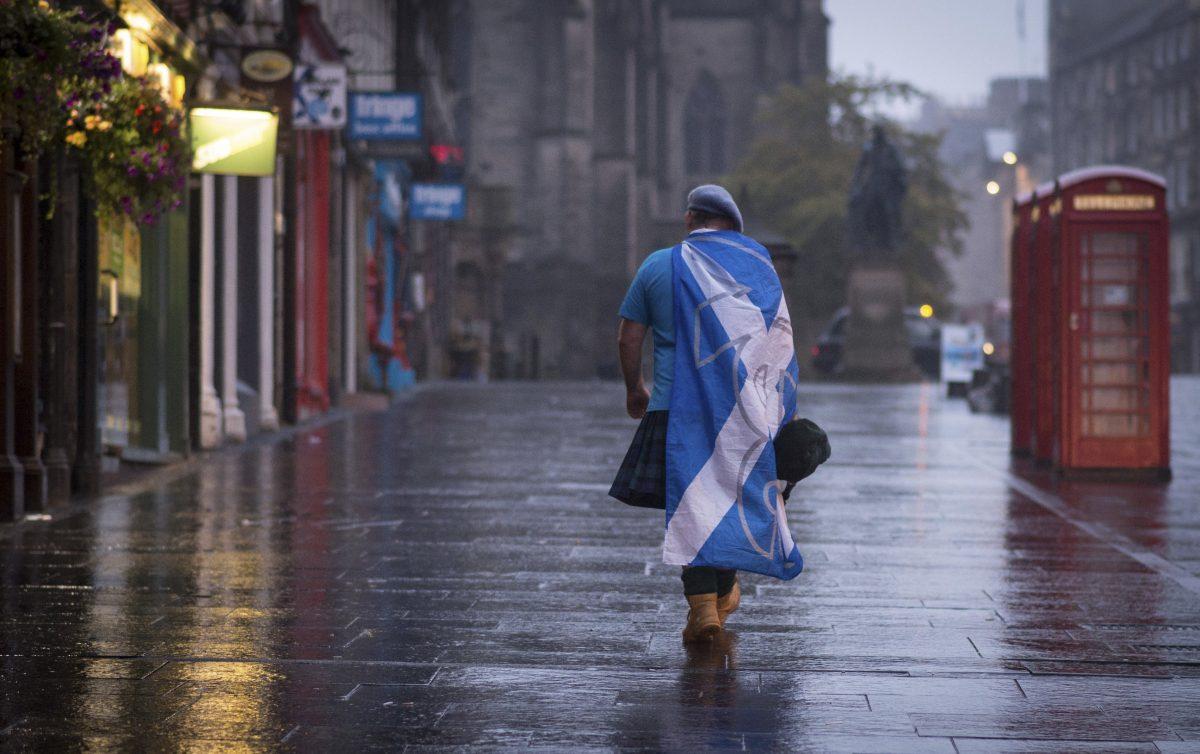 A lone Yes campaign supporter walks down a street in Edinburgh after the result of the Scottish independence referendum, in Scotland on Sept. 19, 2014. (PA, Stefan Rousseau/AP Photo)