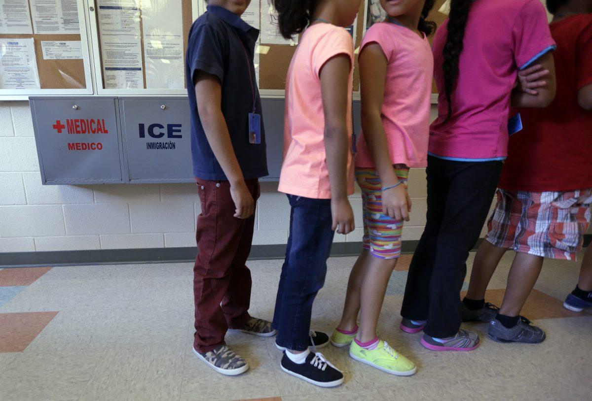 In this Sept. 10, 2014 file photo, detained illegal immigrant children line up in the cafeteria at the Karnes County Residential Center, a temporary home for illegal immigrant women and children detained at the border, in Karnes City, Texas. (AP Photo/Eric Gay, File)