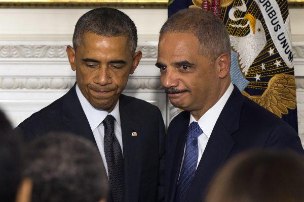 U.S. Attorney General Eric Holder, right, and President Barack Obama during an announcement in the State Dining Room of the White House to announce Holder was resigning, on Sept. 25, 2014. (Evan Vucci/AP Photo)