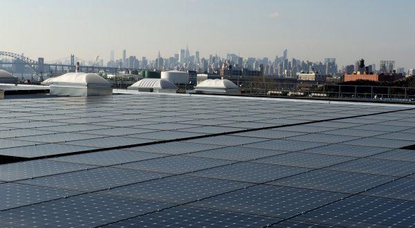 Solar panels on the rooftop in the Bronx, with a view of Manhattan in the distance, on Jan. 17, 2014, in New York. (Don Emmert/AFP/Getty Images)