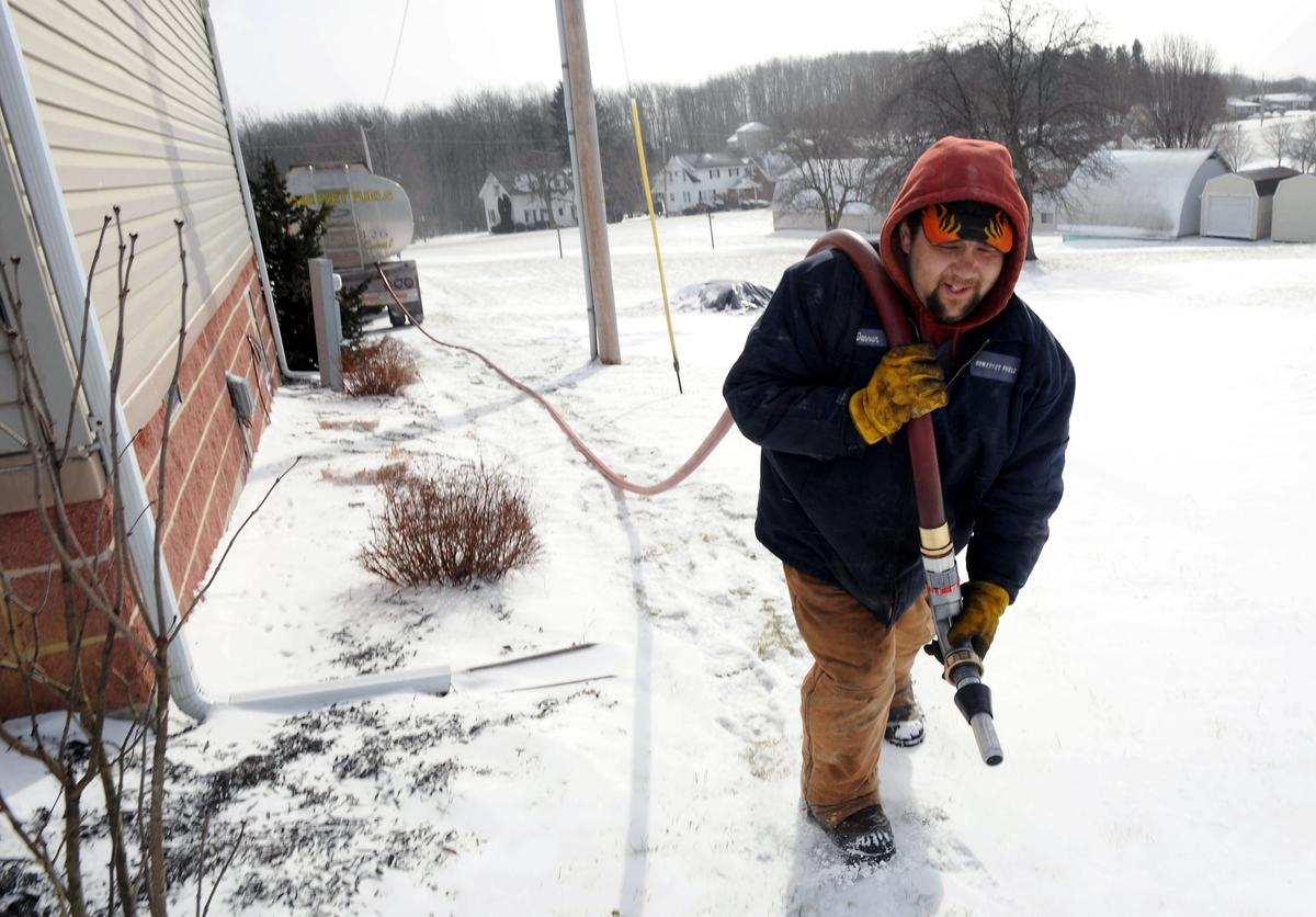 Denver Walker, of Somerset Fuels, makes a heating oil delivery to a home in Jenner Crossroads, Pa., on Jan. 7, 2014. (John Rucosky/AP Photo via Tribune-Democrat)