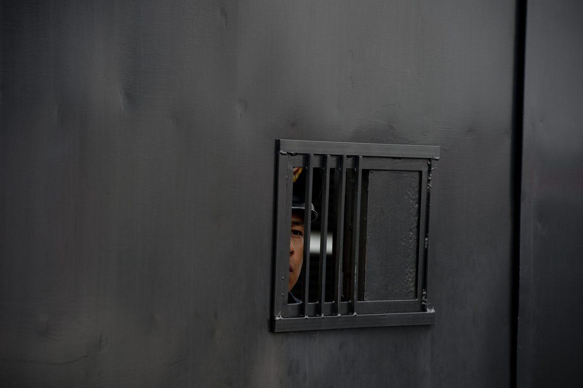A policeman looks through a window in Mexico City on May 25, 2014. (Yuri Cortez/AFP/Getty Images)