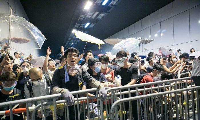 Hong Kong Protesters Storm Key Tunnel in Retaliation for Police Seizure of Road
