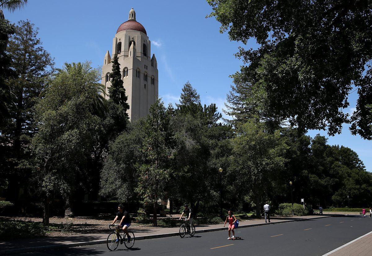 People ride bikes past Hoover Tower on the Stanford University campus in Palo Alto, Calif., on May 22, 2014. (Photo by Justin Sullivan/Getty Images)