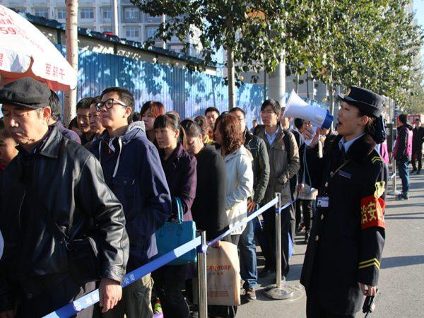 Passengers wait in line to take a subway during the ban on alternate days for odd and even license plates put in place for the APEC Summit in Beijing, China, on November 3, 2014. (ChinaFotoPress/Getty Images)
