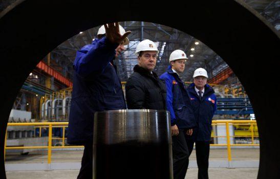 Russian Prime Minister Dmitry Medvedev (2L) is accompanied by Dmitry Pumpyansky (L) the head of TMK, Russia's largest maker of steel pipes for the oil and gas industry, while visiting the Seversky Tube Works in the town of Polevskoy, outside Yekaterinburg, Urals, on Oct. 24, 2014. (Ivan Sekretarev/AFP/Getty Images)