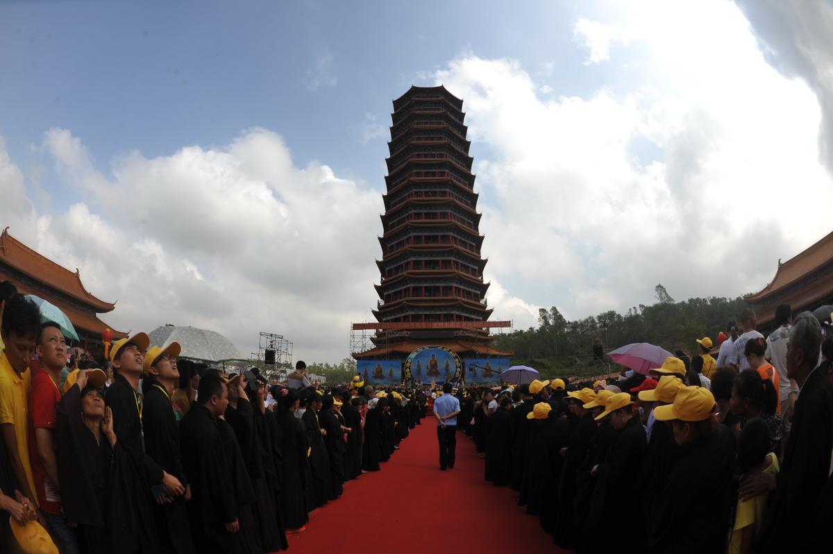 Monks and citizens conduct the ceremony of blessings by seeing the first light of a Buddhist pagoda at Jinshan Temple in Chengmai, Hainan Province, China on Oct. 22, 2014. The practice of religion is off limits for Chinese Communist Party members, according to an opinion piece in Global Times by a high-ranking Party member. (ChinaFotoPress/ChinaFotoPress via Getty Images)
