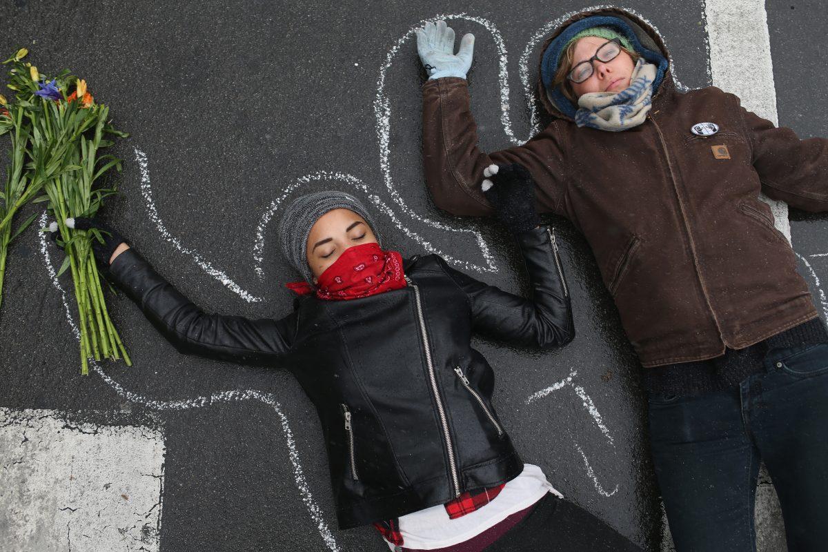 Demonstrators lay on the ground in a mock death protest of the shooting death of Michael Brown by a Ferguson police officer in St. Louis, Missouri on Nov. 16, 2014. (Joe Raedle/Getty Images)