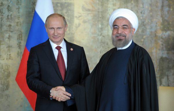 Russia's President Vladimir Putin (L) shakes hands with his Iran counterpart Hassan Rouhani during their bilateral meeting in Shanghai on May 21, 2014. (Alexey Druzhinin/AFP/Getty Images)