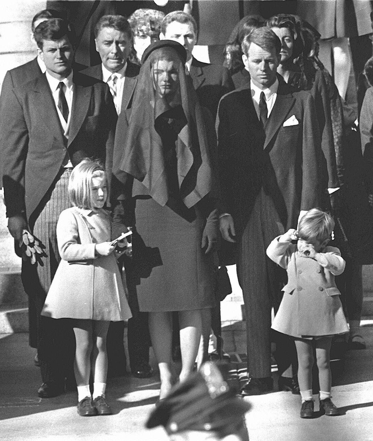 Jacqueline Kennedy (C) stands with her two children Caroline Kennedy (L) and John F. Kennedy, Jr.(R) and brothers-in-law Ted Kennedy (L, back) and Robert Kennedy (2ndR) at the funeral of her husband US President John F. Kennedy in Washington, DC on Nov. 25, 1963. (AFP/Getty Images)