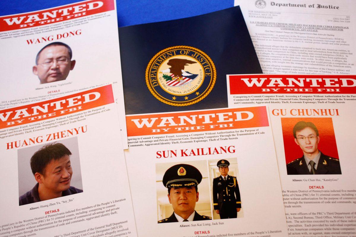 FBI material showing five Chinese military officers wanted on charges of economic espionage and trade secret theft are shown at the Justice Department in Washington on May 19, 2014. (Charles Dharapak/AP Photo)