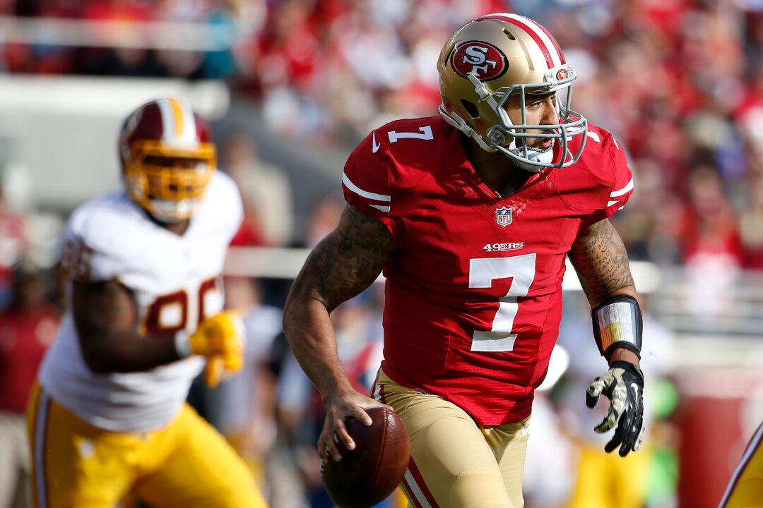 Colin Kaepernick’s Decision to Sit Through Anthem Scrutinized