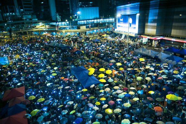 Thousands of Hong Kongers hold umbrellas as their symbol of protest at the Central District in Hong Kong on Oct. 28, 2014. (Benjamin Chasteen/The Epoch Times)