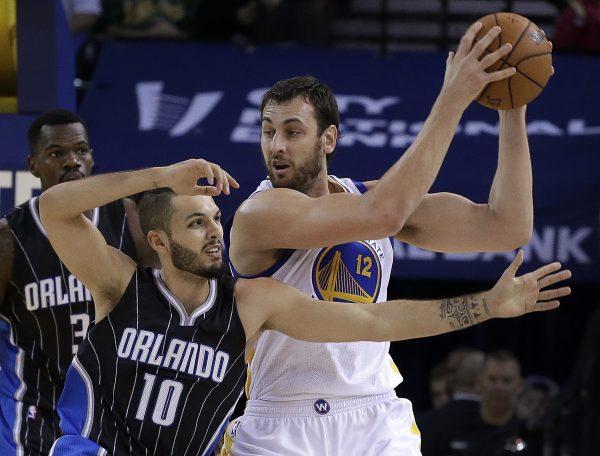 Golden State Warriors' Andrew Bogut, right, keeps the ball from Orlando Magic guard Evan Fournier (10) during the first half of an NBA basketball game Tuesday, Dec. 2, 2014, in Oakland, Calif. (AP Photo/Ben Margot)