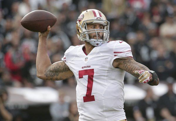 File photo showing now former San Francisco 49ers quarterback Colin Kaepernick (7) passing against the Oakland Raiders during the second quarter of an NFL football game in Oakland, Calif., Sunday, Dec. 7, 2014. (AP Photo/Marcio Jose Sanchez)