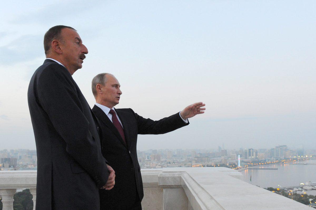 Russian President Vladimir Putin (R) and Azerbaijani President Ilham Aliyev speak as they walk in Baku, Azerbaijan, on Aug. 13, 2013. (Mikhail Klimentyev/AFP/Getty Images)