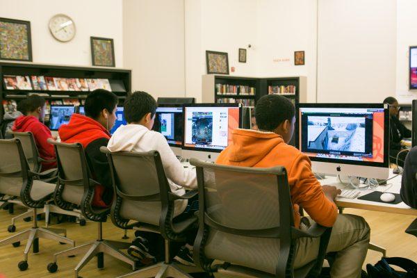 Students play video games on the public computers at the recently renovated Washington Heights public library in Manhattan on Dec. 10, 2014. (Benjamin Chasteen/Epoch Times)