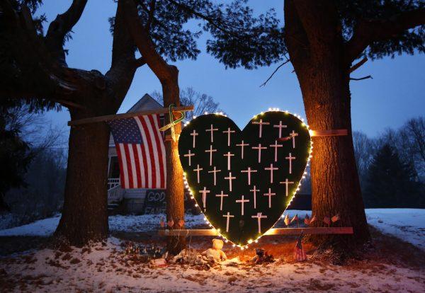 A makeshift memorial with crosses for the victims of the Sandy Hook Elementary School shooting massacre stands outside a home in Newtown, Conn., on the one-year anniversary of the shootings on Dec. 14, 2013. (Robert F. Bukaty/AP/File)