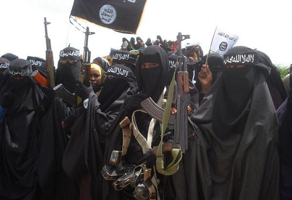 Somali women carry weapons during a demonstration organized by the extremist group al-Shabab in the Suqa Holaha neighborhood of Mogadishu on July 5, 2010. (Abdurashid Abikar/AFP/File Photo via Getty Images)