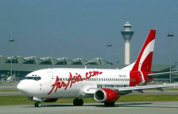 An aircraft of Malaysia's domestic airline, AirAsia, preparing for take-off as it passes the Kuala Lumpur International Airport control tower on Feb. 8, 2003. (Roslan Rahman/AFP/Getty Images)