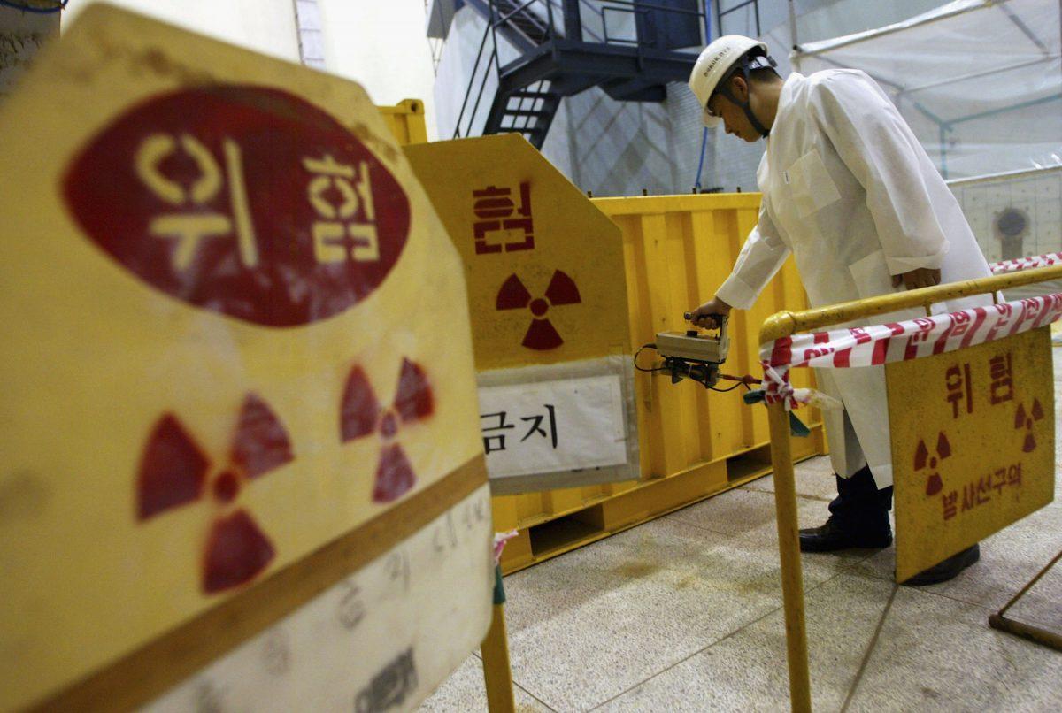 A South Korean nuclear scientist tests a partly dismantled experimental reactor for radiation in part of at a Korea Atomic Energy Research Institute in Seoul, South Korea, on Sept. 10, 2004. (Chung Sung-Jun/Getty Images)
