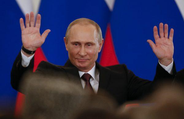 Russian President Vladimir Putin gestures after signing a treaty to incorporate Crimea into Russia in the Kremlin in Moscow, Russia, on March 18, 2014. In his New Year’s Eve televised message to the nation, Putin hailed the annexation of Crimea as a historic achievement and the rightful return of the peninsula’s people to the bosom of Russia. (Alexander Zemlianichenko/AP Photo)