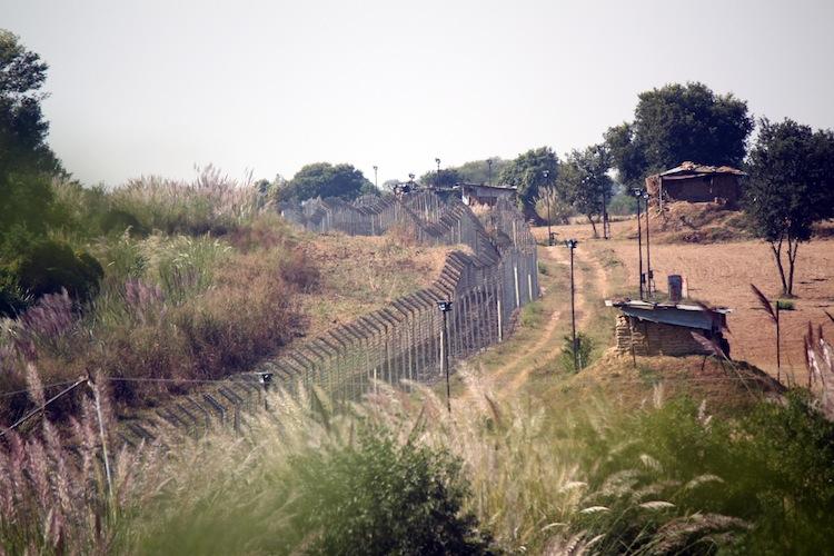 The fence erected within the Indian territory near the India-Pakistan International Border along with floodlights at Chak Changa village at Hiranagar, Jammu State, India, in October 2012. (Venus Upadhayaya/The Epoch Times)