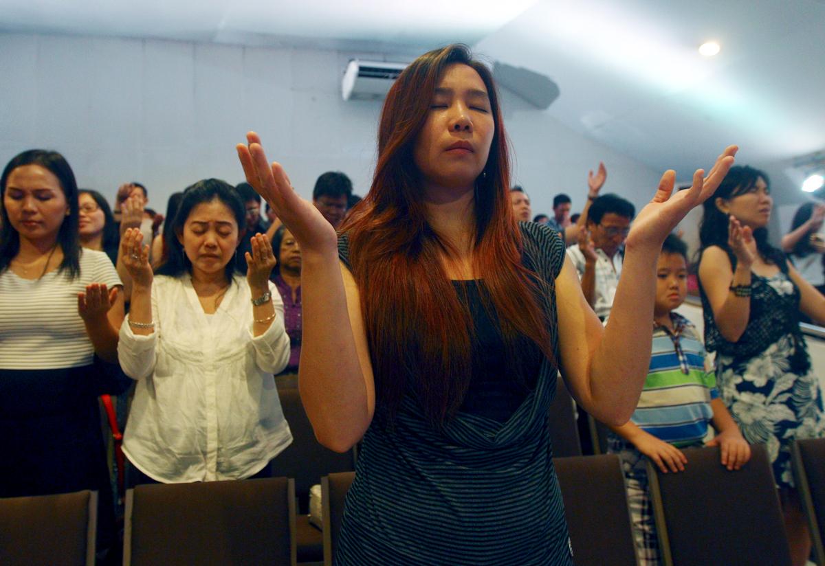 Exhausted AirAsia Victims' Families Cry and Sing in Tiny Chapel