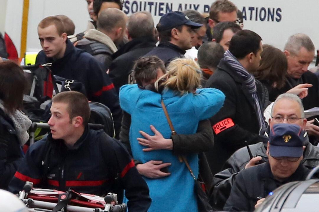 Charlie Hebdo Suspect Surrenders, Two Brothers Still at Large