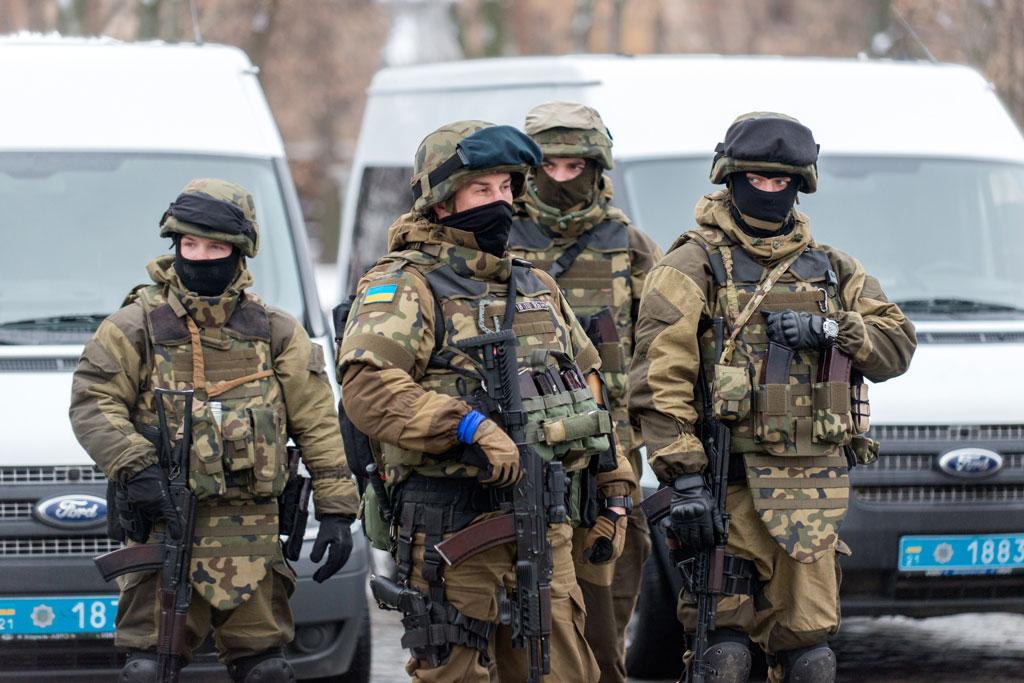 Police personnel and National Guard troops stand near armored cars in the northeastern Ukrainian city of Kharkiv, on Jan. 22, 2015. (Sergey Bobok/AFP/Getty Images)