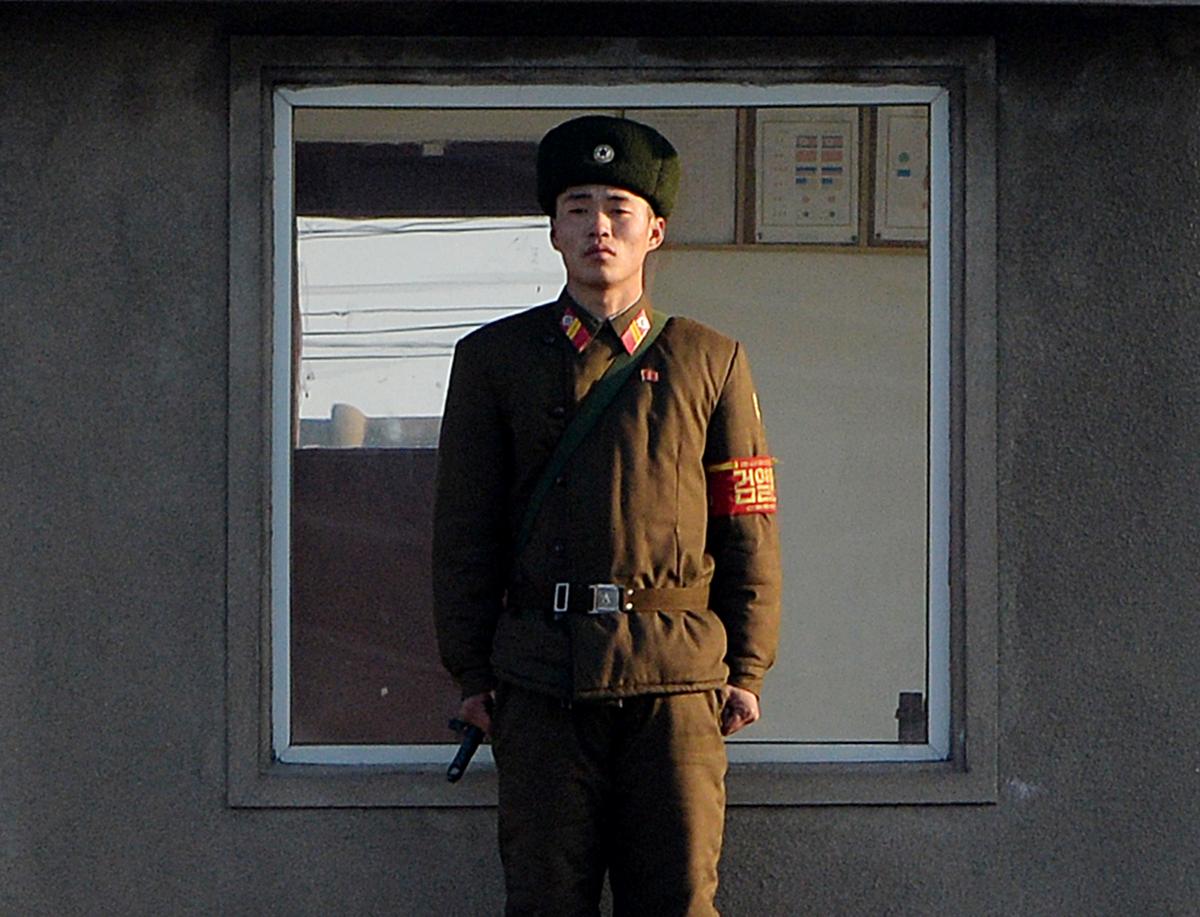 A North Korea soldier stands guard on the banks of the Yalu River which separates the North Korean town of Sinuiju from the Chinese border town of Dandong on Dec. 17, 2013. (Mark Ralston/AFP/Getty Images)