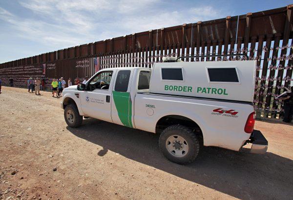 A U.S. Customs and Border Patrol agent patrols along the Arizona-Mexico border wall in Hereford, Ariz., on Aug. 15, 2010. (Matt York/AP Photo)