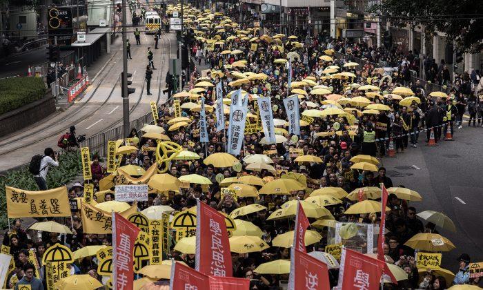 Hongkongers Raise Umbrellas, March to Protest Beijing’s Democracy Plan
