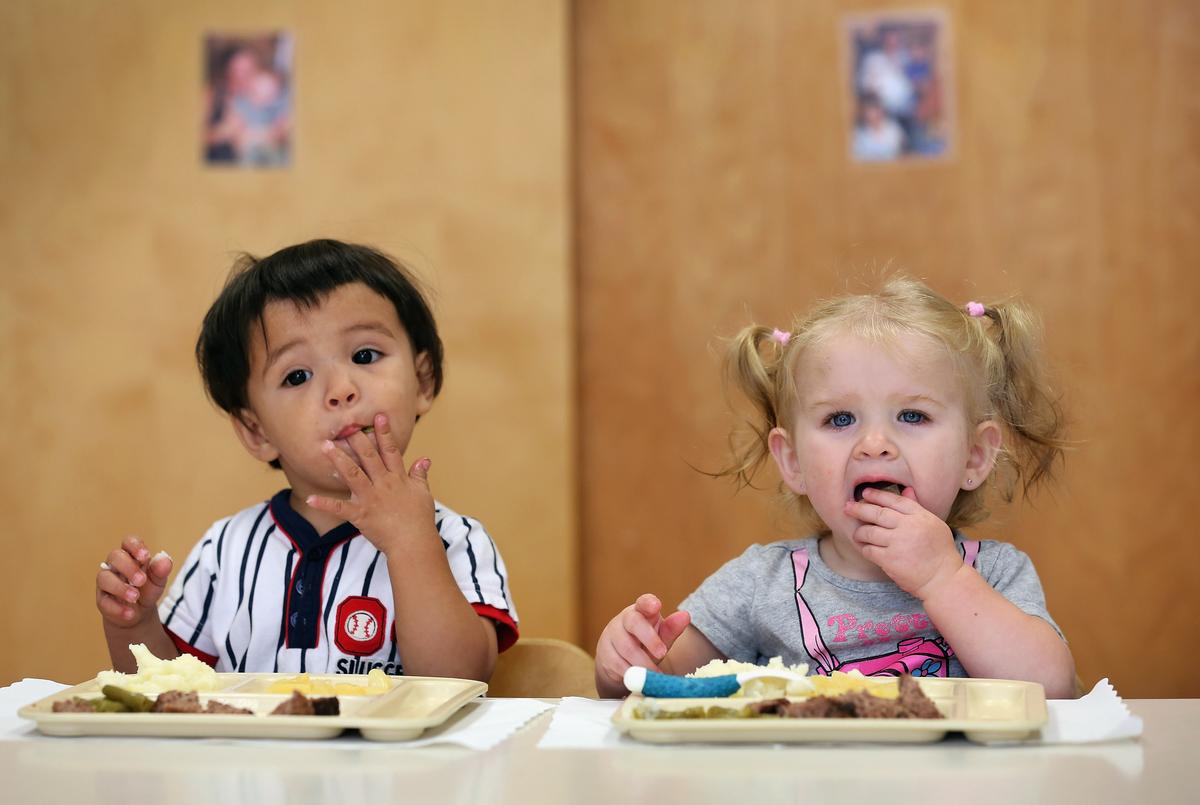 Children eat food at a school cafeteria in Woodbourne, N.Y, on Sept. 20, 2012. (John Moore/Getty Images)