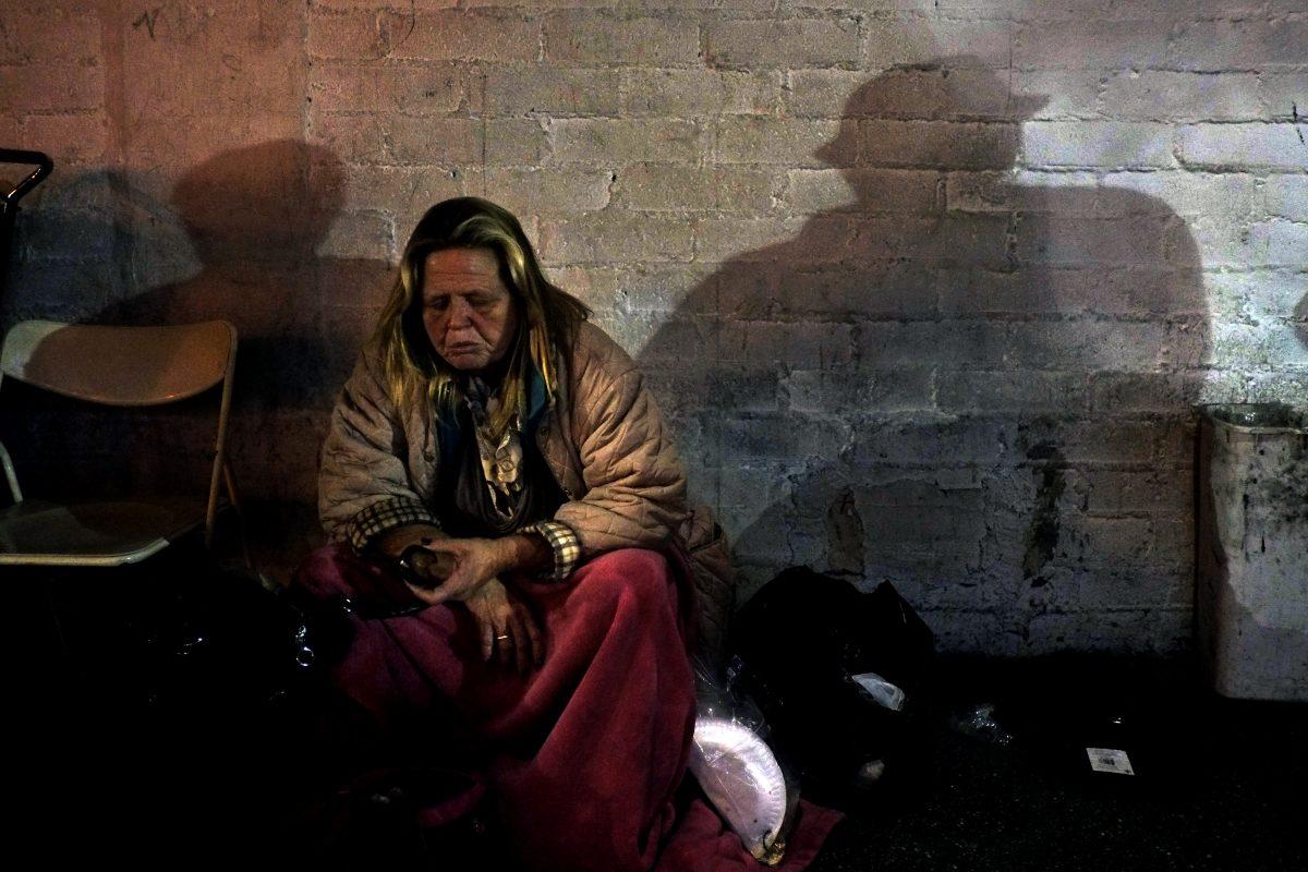 A homeless woman eats an apple in Skid Row, Los Angeles, on March 21, 2013. (AP Photo/Jae C. Hong)