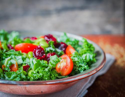 Generally, colorful fruits and vegetables contain higher antioxidant levels, so eat up! Blueberries, pomegranates, cranberries, kale and spinach are all great examples.(<a href="http://www.shutterstock.com/pic-202535074/stock-photo-kale-and-edamame-salad-on-rustic-background.html?src=UEZ-3i92gZNcFM1jkr2jXA-1-15&ws=1" target="_blank" rel="noopener">Shutterstock</a>)
