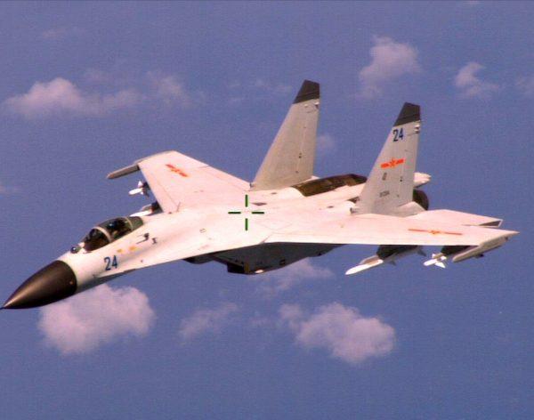 An armed Chinese J-11 fighter jet, a 1992 copy of the Russian Su-27, flies near a U.S. patrol aircraft over the South China Sea in international airspace on Aug. 19, 2014. (U.S. Navy Photo/Released)