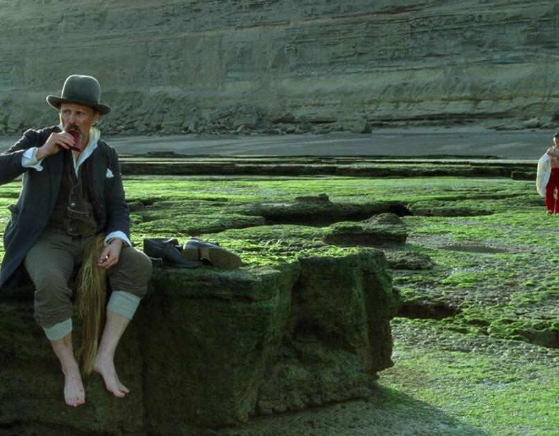 Gunnar Dinesen (Viggo Mortensen) has a drink, while looking at grass, in "Jauja." (The Cinema Guild)