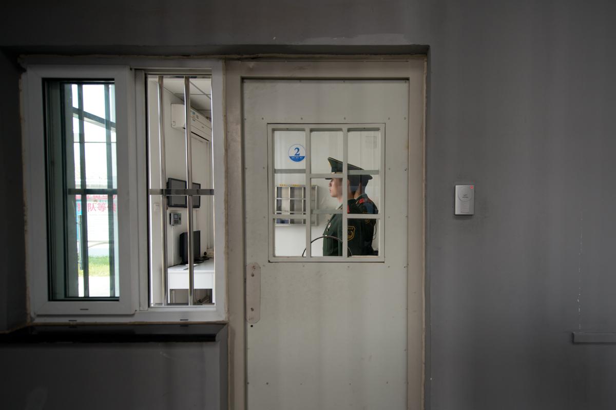 A paramilitary guard stands at a security door inside the No.1 Detention Center during a government guided tour in Beijing on Oct. 25, 2012. (Ed Jones/AFP/Getty Images)